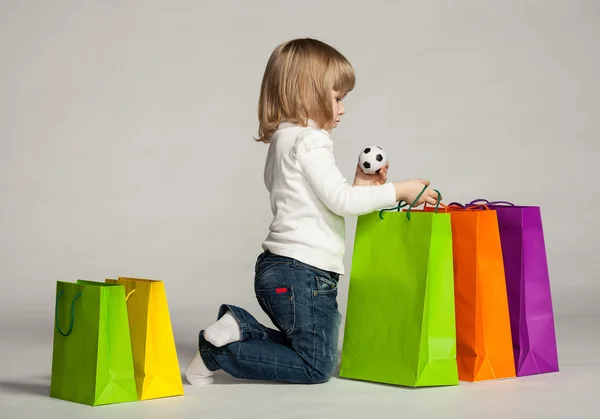 depositphotos_20815871-stock-photo-little-girl-sitting-near-shopping